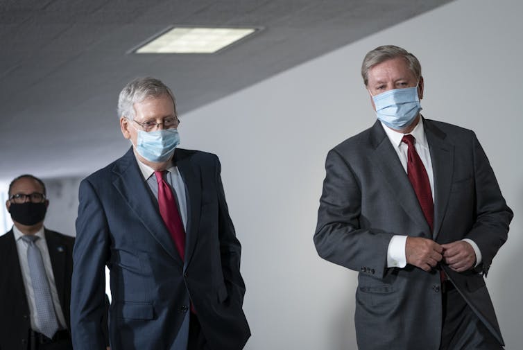 Senate Majority Leader Mitch McConnell and Sen. Lindsey Graham walking together