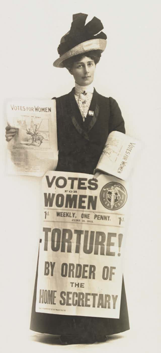 Suffragette with protest signs