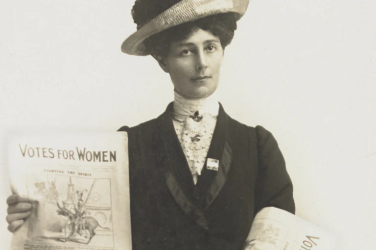 Suffragette with protest signs