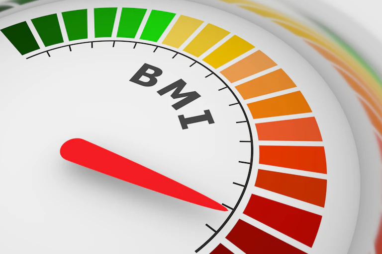An arc-shaped BMI scale with colour gradations from green through yellow, orange and red, with a red pointer indicating a BMI in the red range.