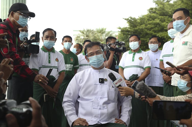 Than Htay, centre, chairman of the military-backed Union Solidarity and Development Party (USDP), talks to journalists.