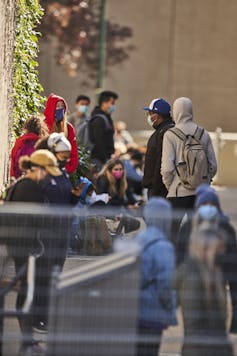 Students stand in a line.