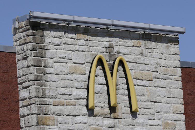 The McDonald's golden arches logo is pictured on a brick wall at one of the fast food chain's restaurants.