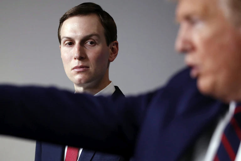 Jared Kushner watches Donald Trump as he speaks.