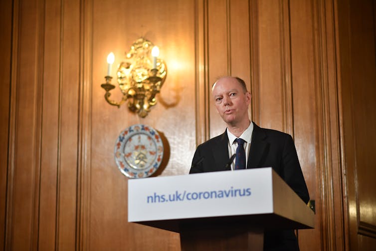 Professor Chris Whitty, England's chief medical officer, at a podium.