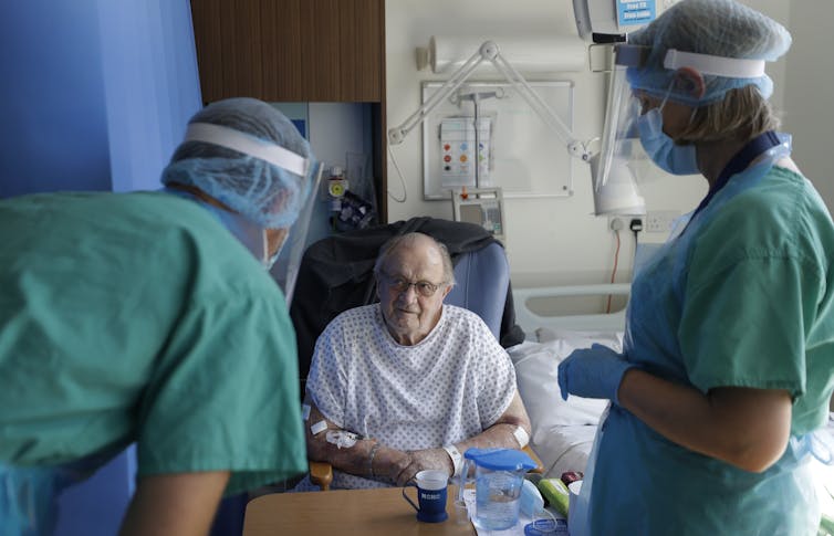 Fewer people attended hospital with stroke during the pandemic – but why? 14 A patient in hospital, being attended to by two staff wearing PPE