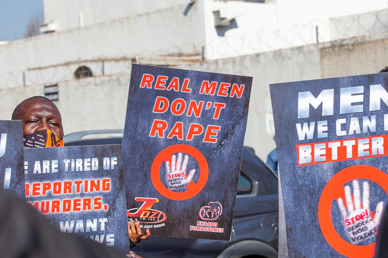 Protesters holding up signs.
