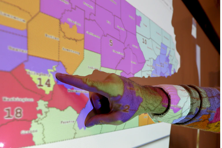 A finger points at a map
