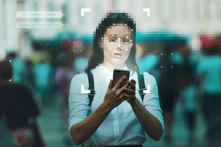 A young white woman with a pixelated face lit by her cellphone