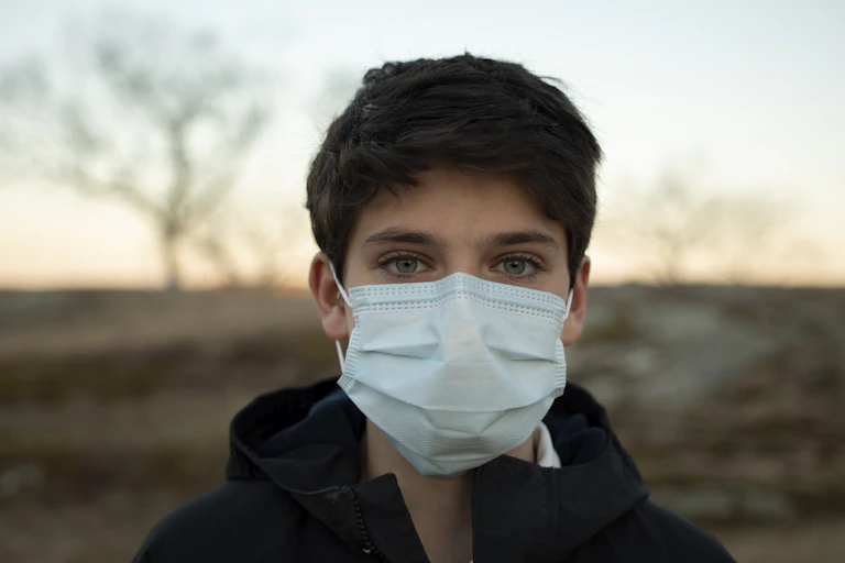 boy wearing mask outside