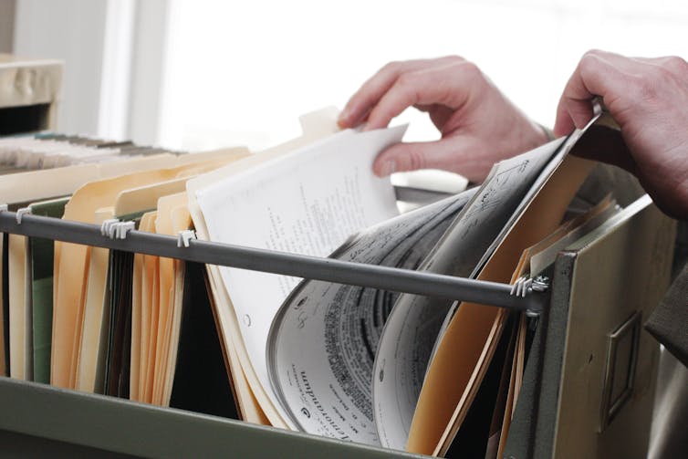 Open filing cabinet, with paper files