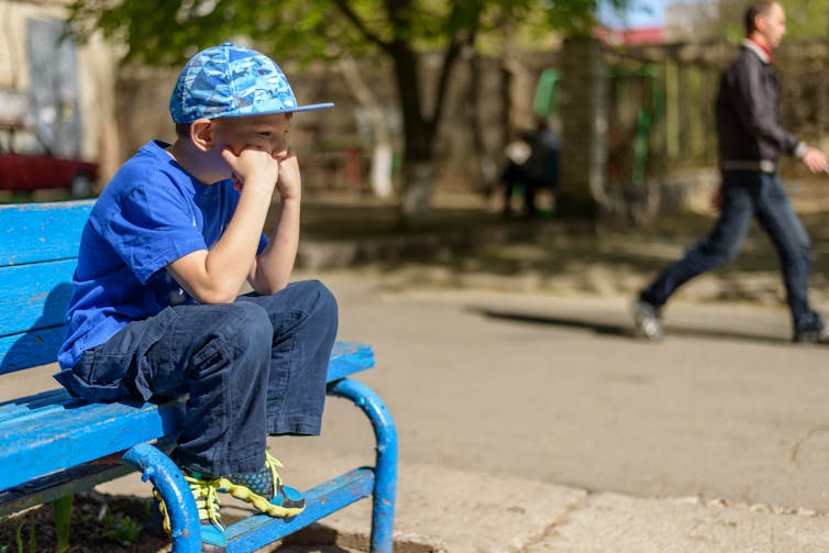 Picture of a boy looking bored.