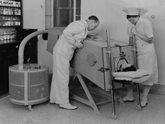 Polio patient in an iron lung to help them breathe.