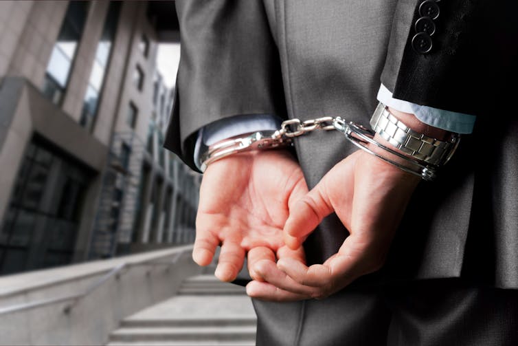 Picture of a man in handcuffs.