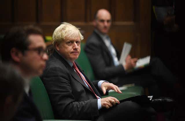 Boris Johnson sits in parliament. 