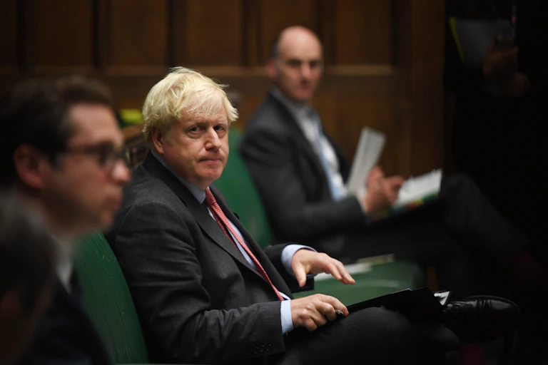 Boris Johnson sits in parliament.