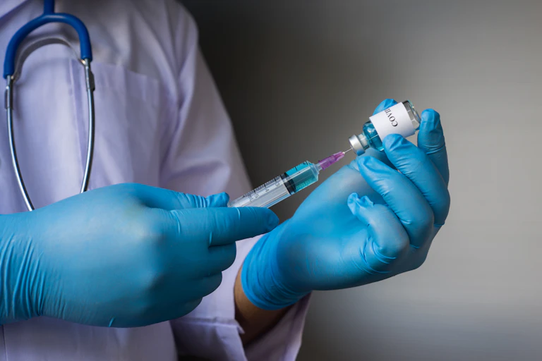 Medic prepares to inject a coronavirus vaccine