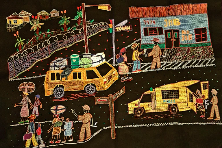 Embroidery depicting an urban scene including police.