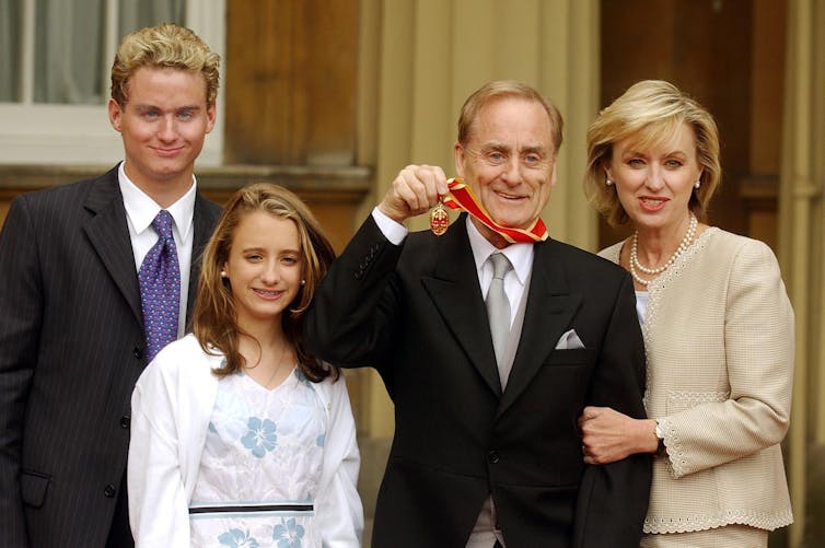 Harold Evans and his wife Tina Brown and two teenage children outside Buckingham Palace.