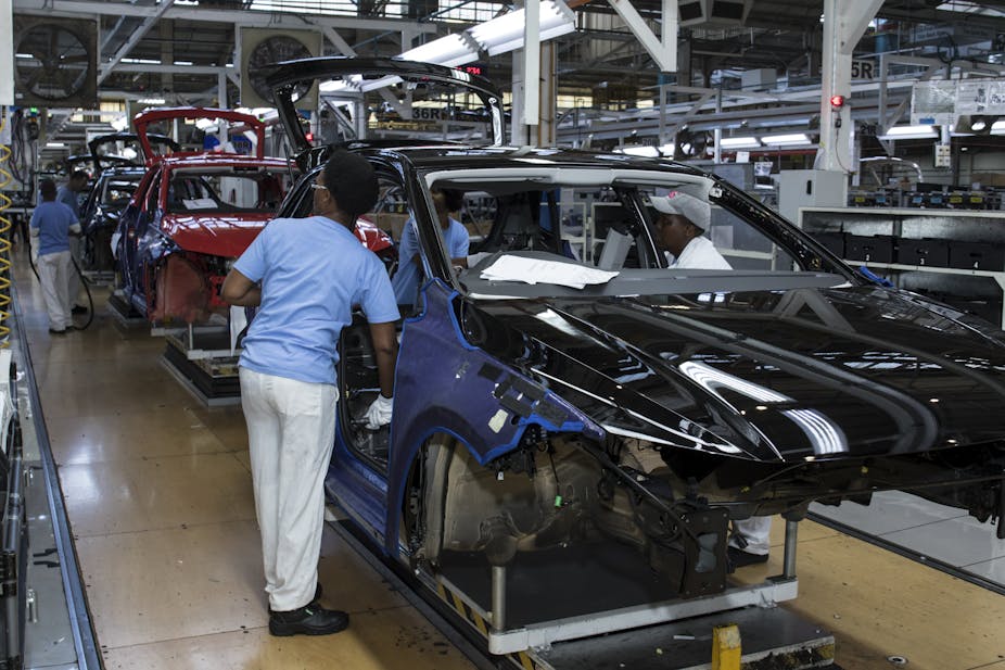 Workers of automotive manufacturer VW assemble pieces of a model in the Uitenhage plant