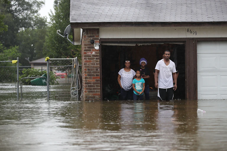 A family waits in their garage to be rescued during Hurricane Harvey.