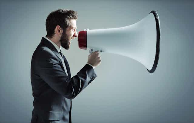 Man shouts into massive megaphone