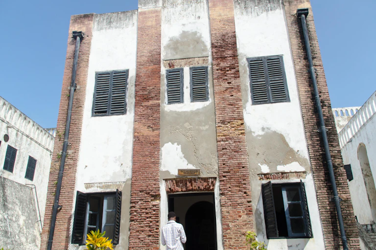 A tourist at the entrance of Elmina castle museum