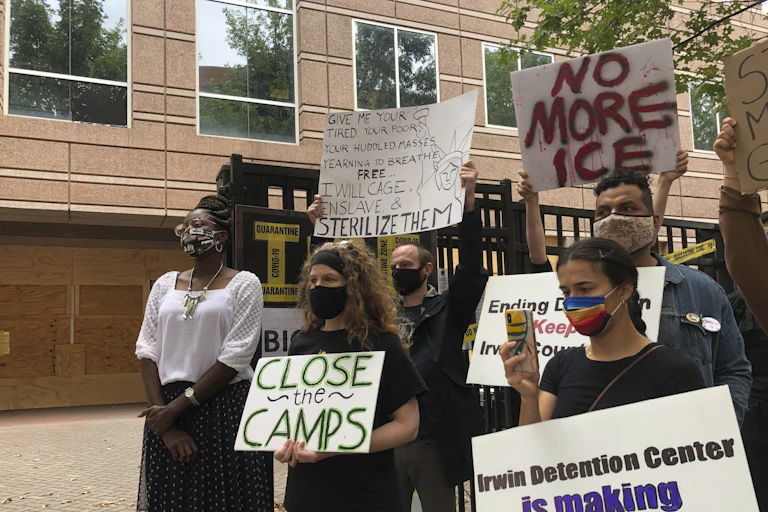 A group of protestors with placard pose for photos.