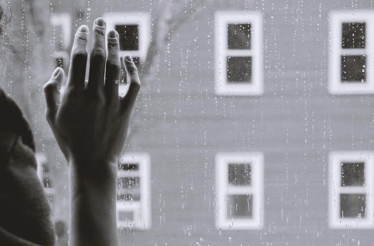 'No physical injuries' minimizes the emotional trauma of assault survivors 13 A woman's hand rests against a rain-spattered window pane.