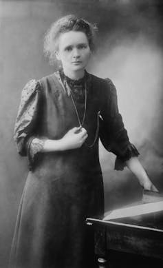 A black and white photograph of Marie Curie