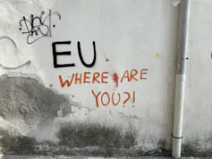 Graffiti reading 'EU, where are you?' on a white wall.