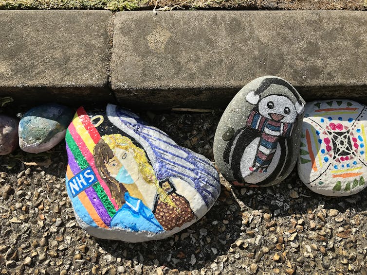 Colourful designs painted on pebbles
