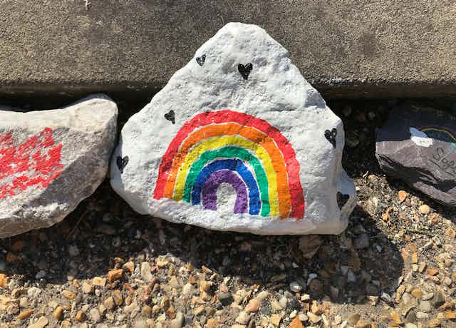 Stone with a rainbow painted on it.