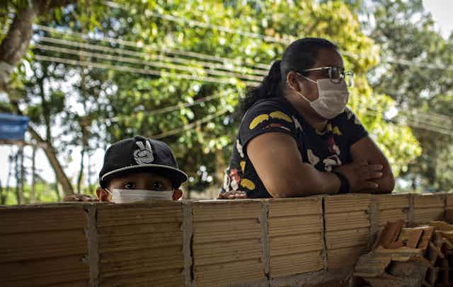 A woman and her young son wearing masks in Manaus, Brazil.