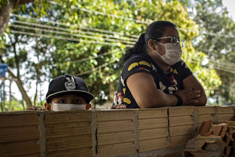 A woman and her young son wearing masks in Manaus, Brazil.