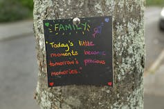 Note of positivity pinned to a tree