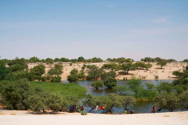 Chadian women wash their clothes on teh side of Lake Chad.