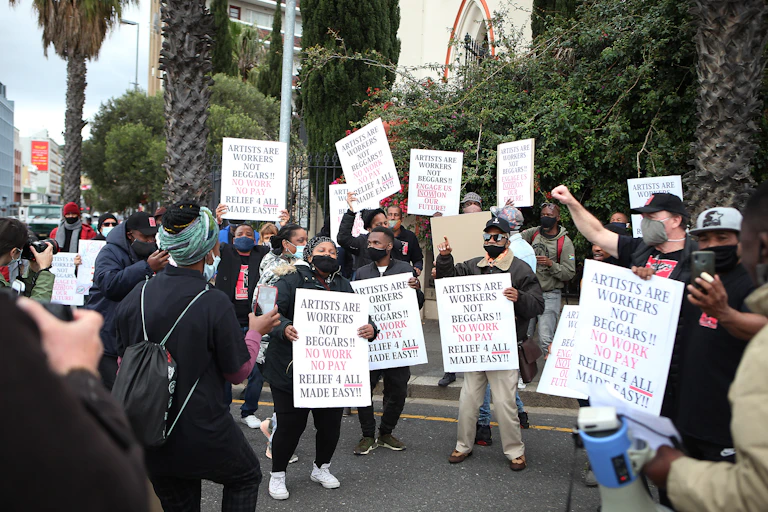 Protesters holding up signs
