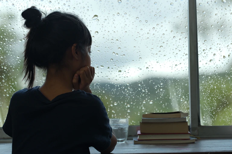 Girl looking out of a window