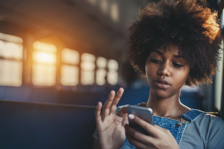 Young black woman looking at phone