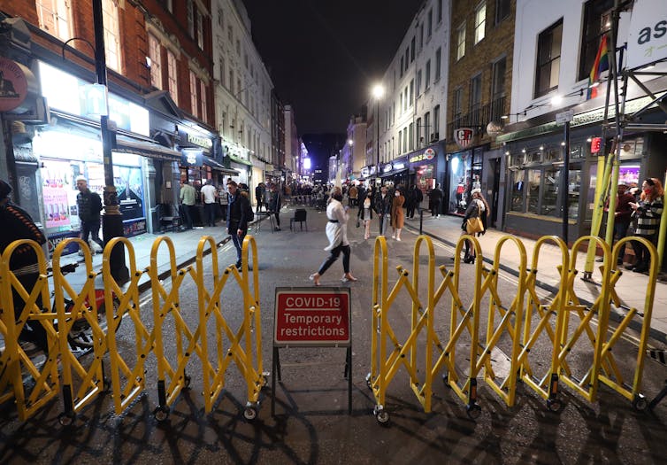 A yellow barrier bars access to a London street.
