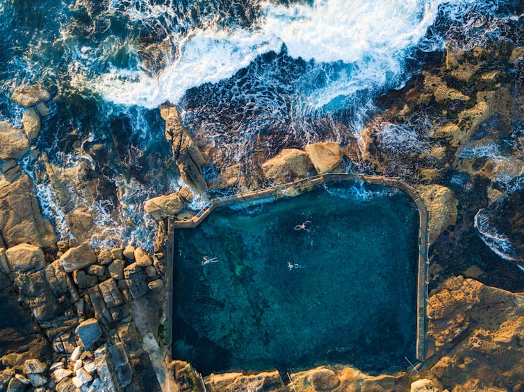 An aerial shot of an ocean pool.