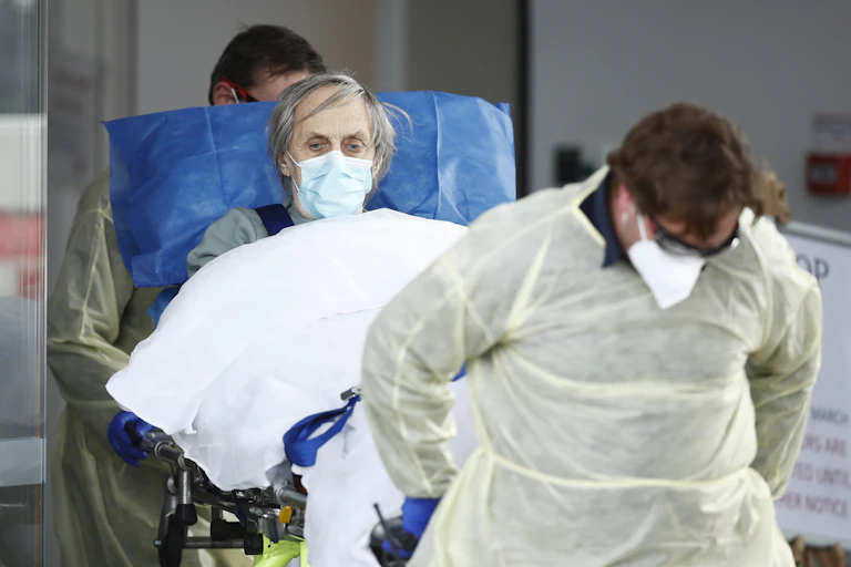 A person is wheeled out of an aged care facility amid the coronavirus pandemic