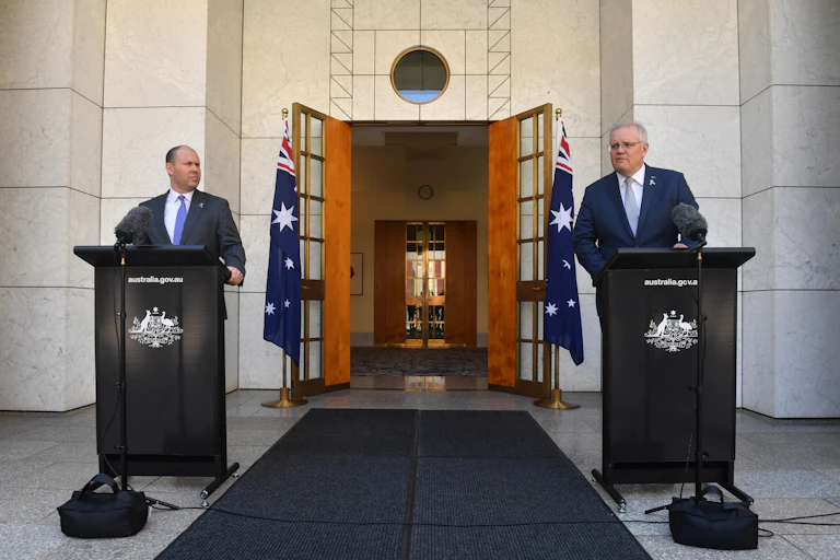 Treasurer Josh Frydenberg and Prime Minister Scott Morrison speak at a press event.