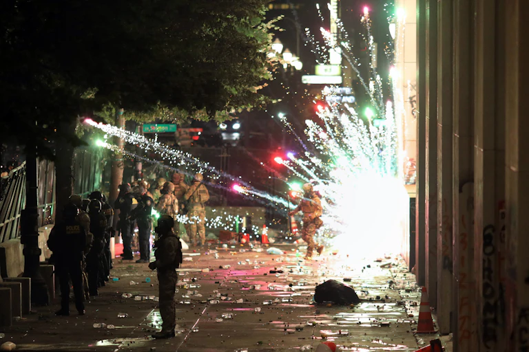 Sparks of an explosion next to policemen