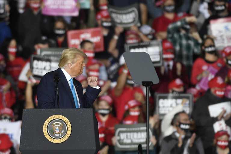 Donald Trump gestures at a crowd
