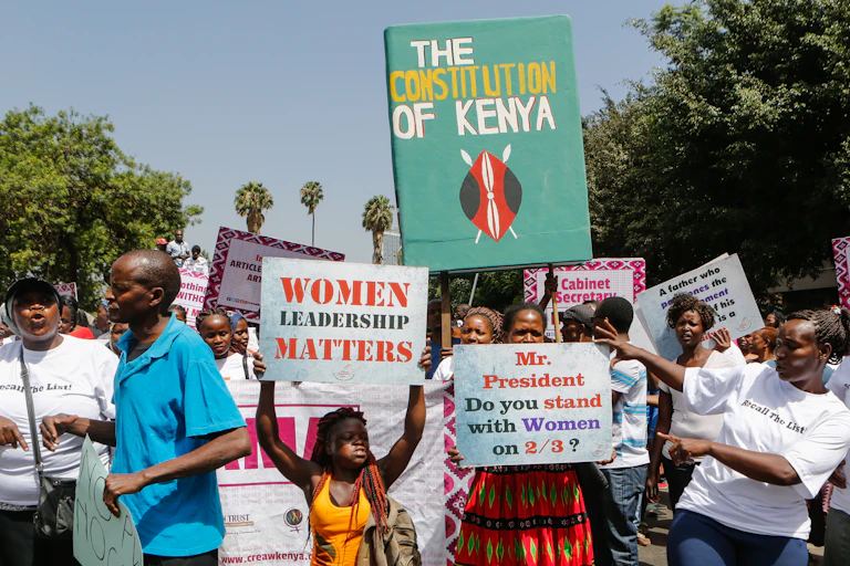 People carry placards in a street protest