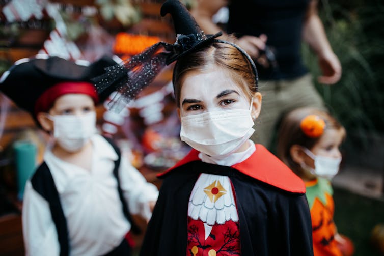 While trick-or-treating, everyone in your family must wear a mask and socially distance from others.