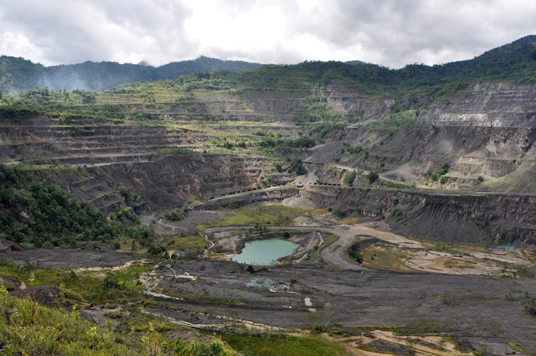 A mine, with a bright blue pool in the centre.