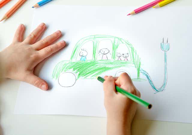 A child drawing an electric car